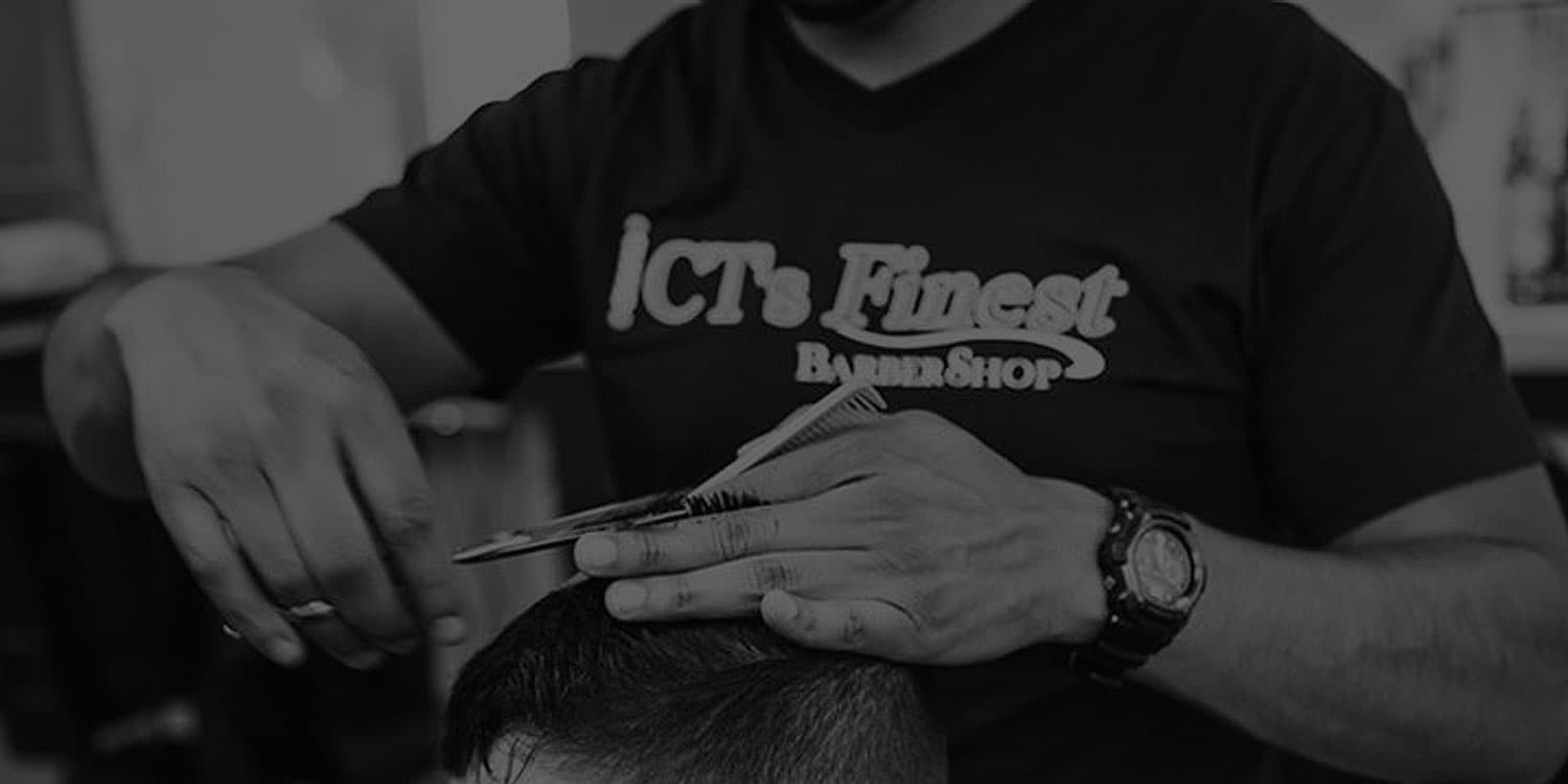 A CT's Finest barber trimming a client's hair with scissors and comb